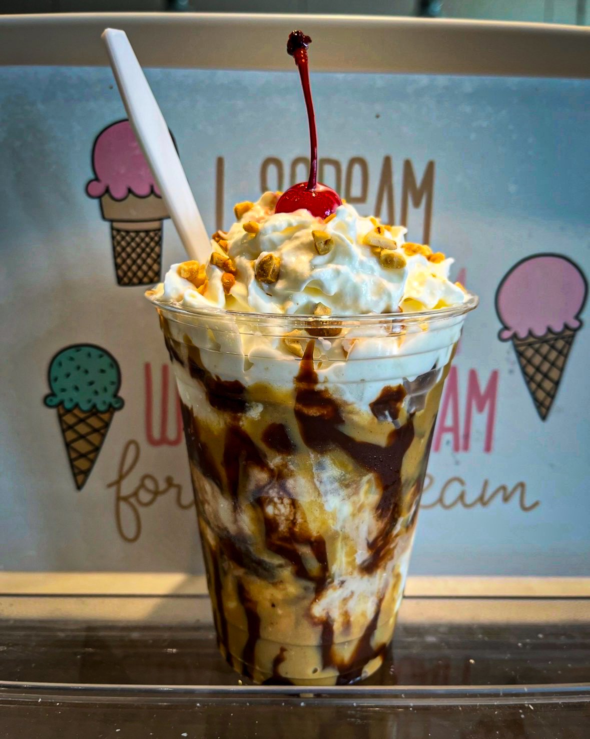 Main St. Ice Cream sundae with chocolate, peanut butter, whipped cream, nuts and a cherry