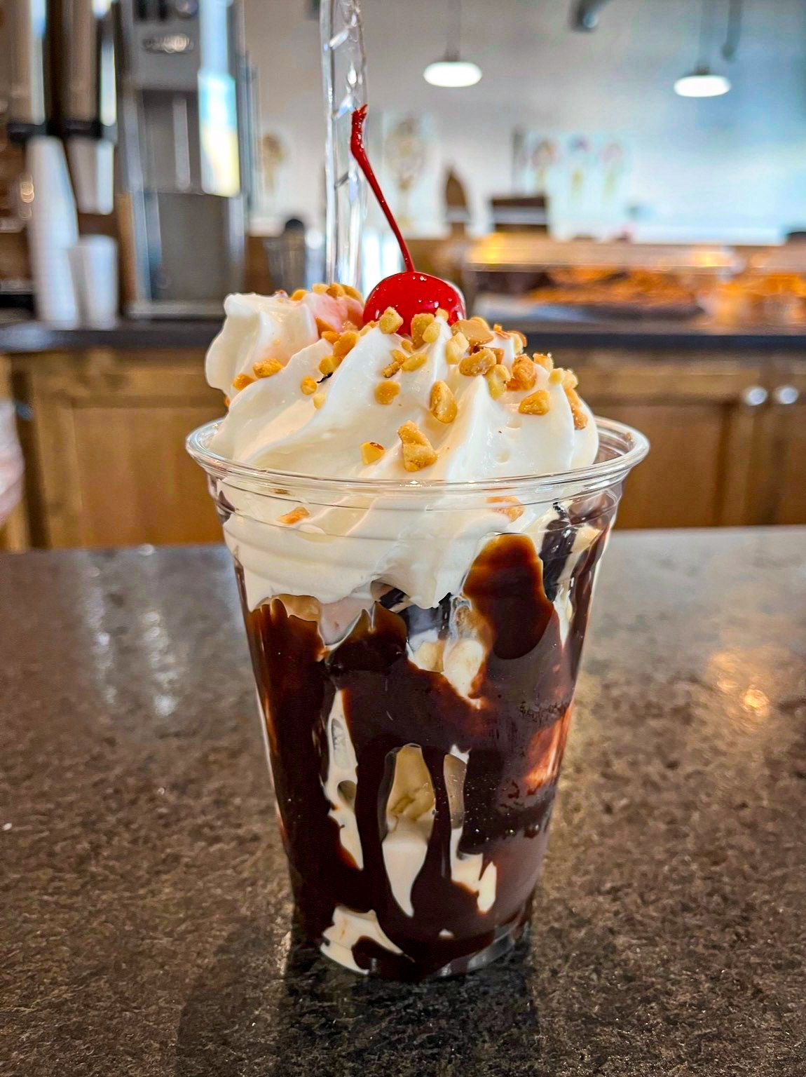 Hot fudge sundae with whipped cream, nuts and a cherry at Main St. Ice Cream