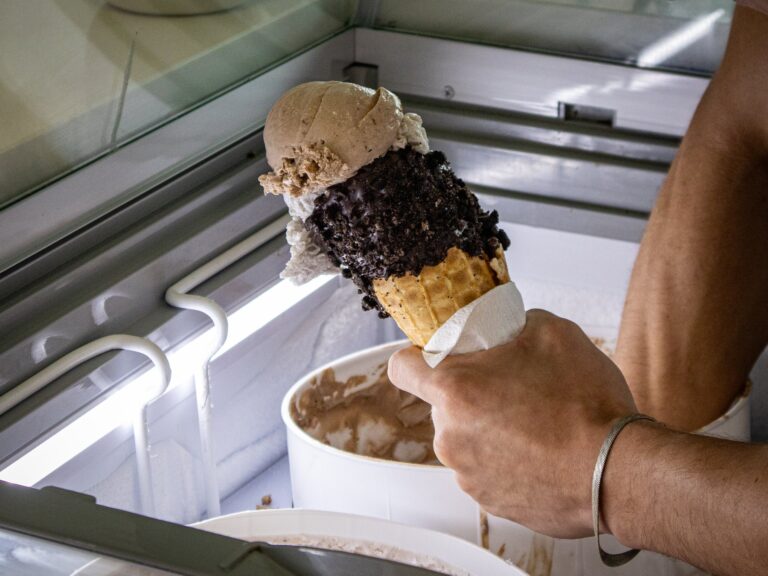A handmade ice cream cone being scooped in the Main St. Ice Cream shop